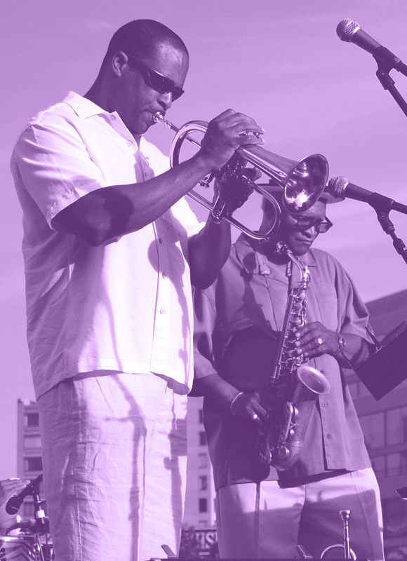 Jazz in June concert performers play trumpet and saxophone on stage