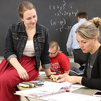 Math graduate student Hayley Olson assists teacher Tara Free during Math 810T Algebra for Algebra Teachers