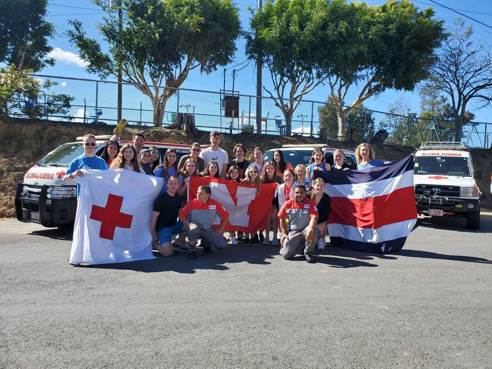 Students on a track holding a nebraska flag.