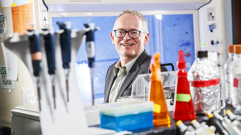 Janos Zempleni smiles for a photo in a scientific lab space. 