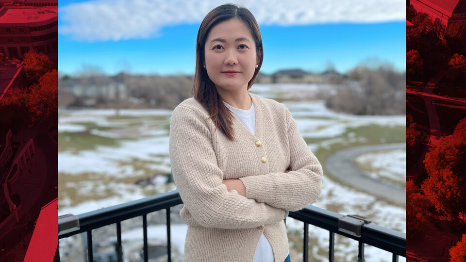 Yao Yao poses for a portrait on a balcony