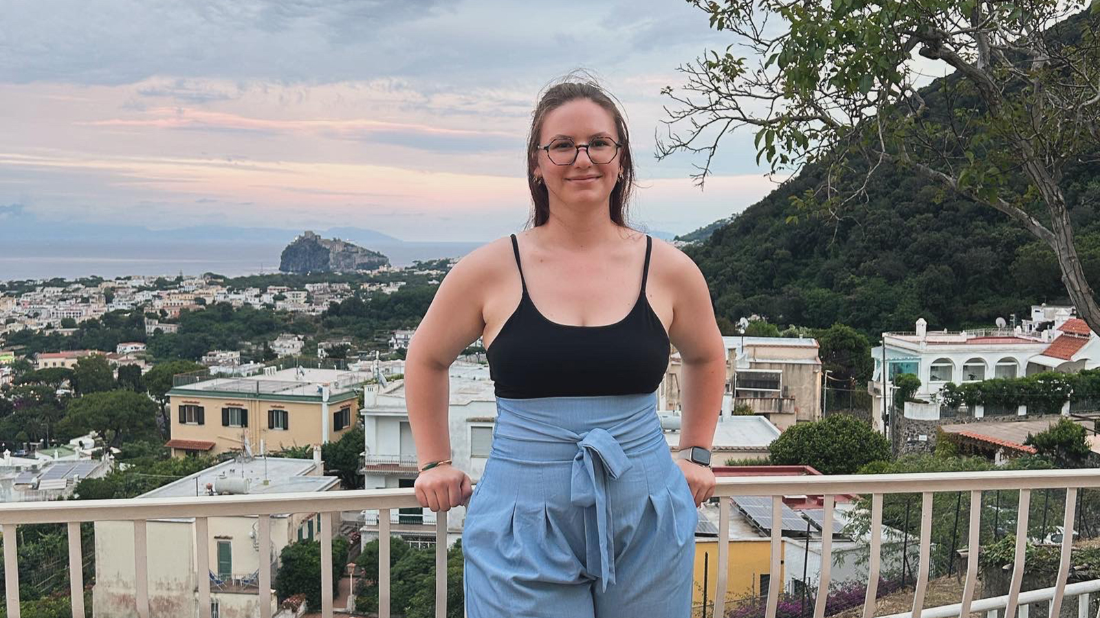 Tayler Trotta poses for a photo above the city in Italy