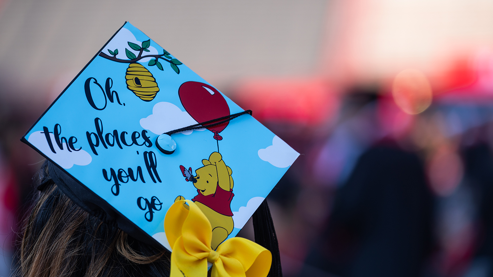 graduation cap decorated with Winnie the Pooh and the words "Oh the places you'll go"