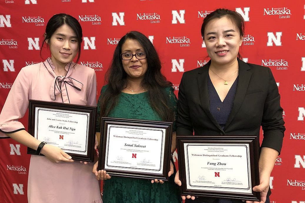 Alice, Sonal, and Fang at the fellowship ceremony