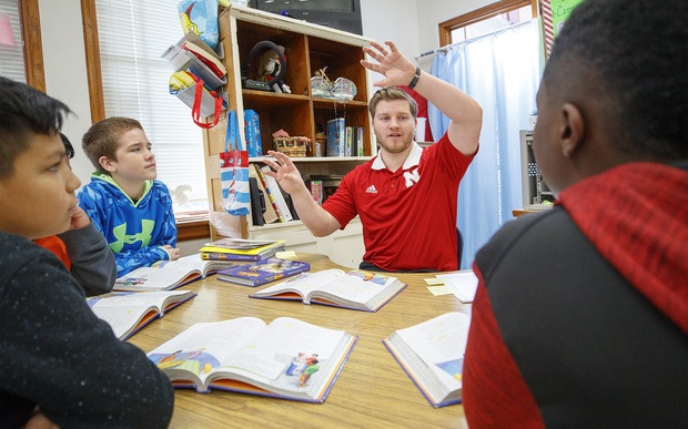 Photo of teacher meeting with students.