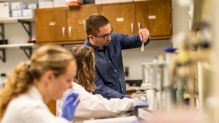 Assistant Professor Ivan Vechetti works alongside two students in his research lab