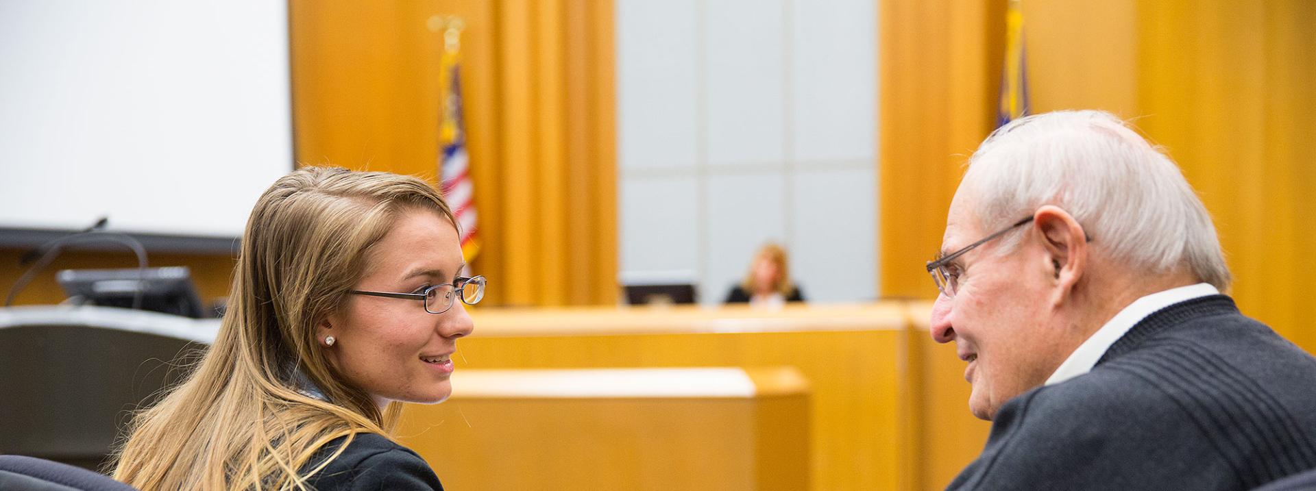Student and mentor in a courtroom