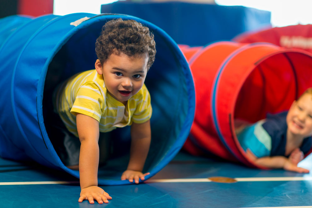 child crawling out of a tube