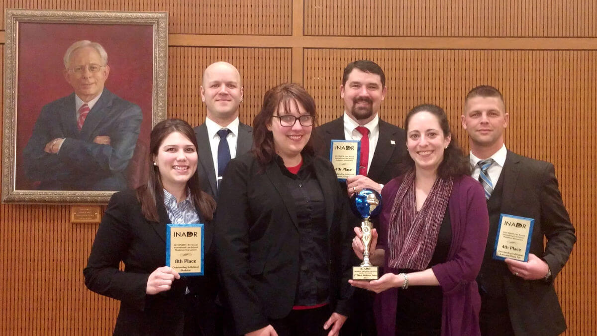 Students holding awards inside courtroom