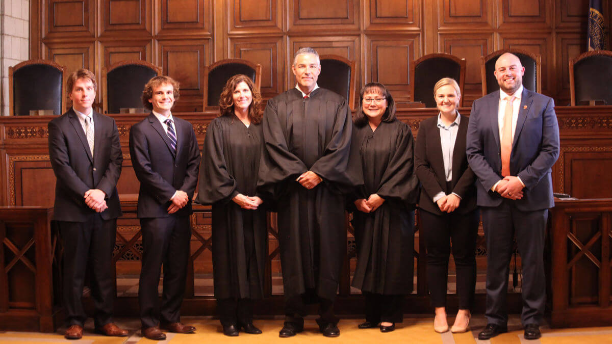 Students standing inside courtroom