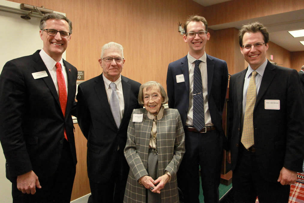 Students and faculty pose with alumni